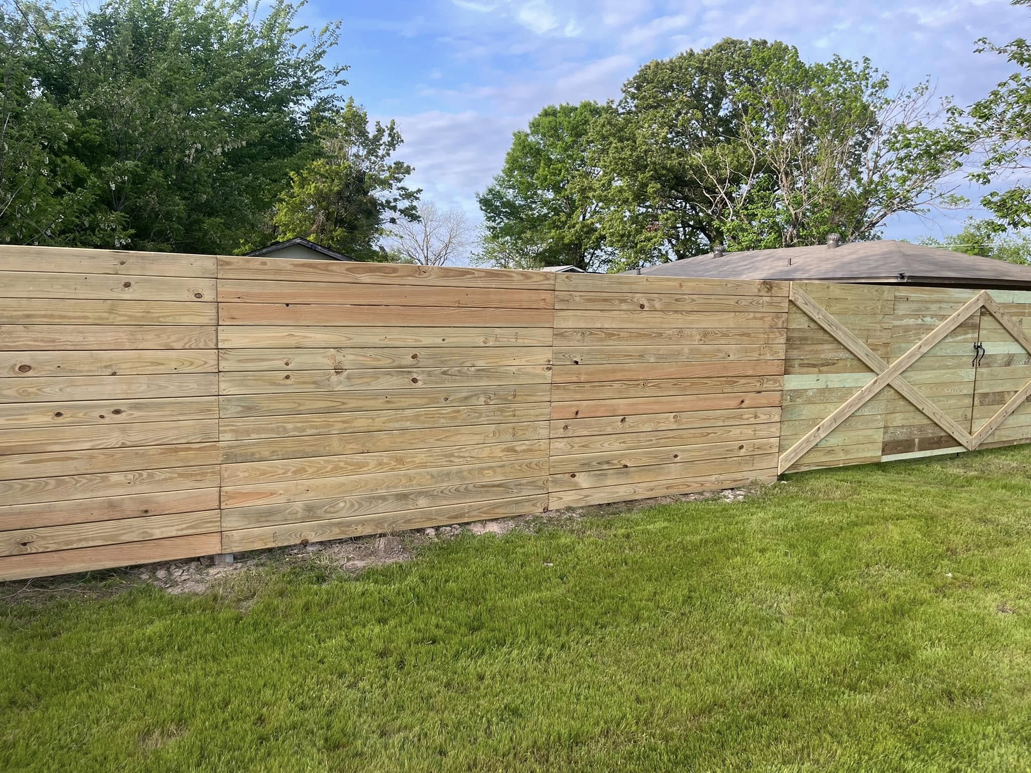 Wooden privacy fence installation in residential backyard for improved security and property value – Hood Lawn Care and Services