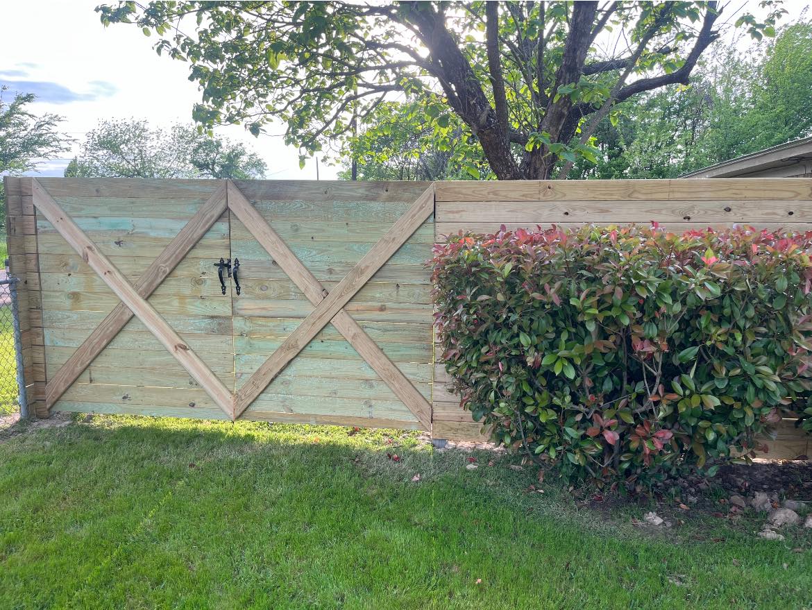 Wooden privacy fence installation in residential backyard for improved security and property value – Hood Lawn Care and Services